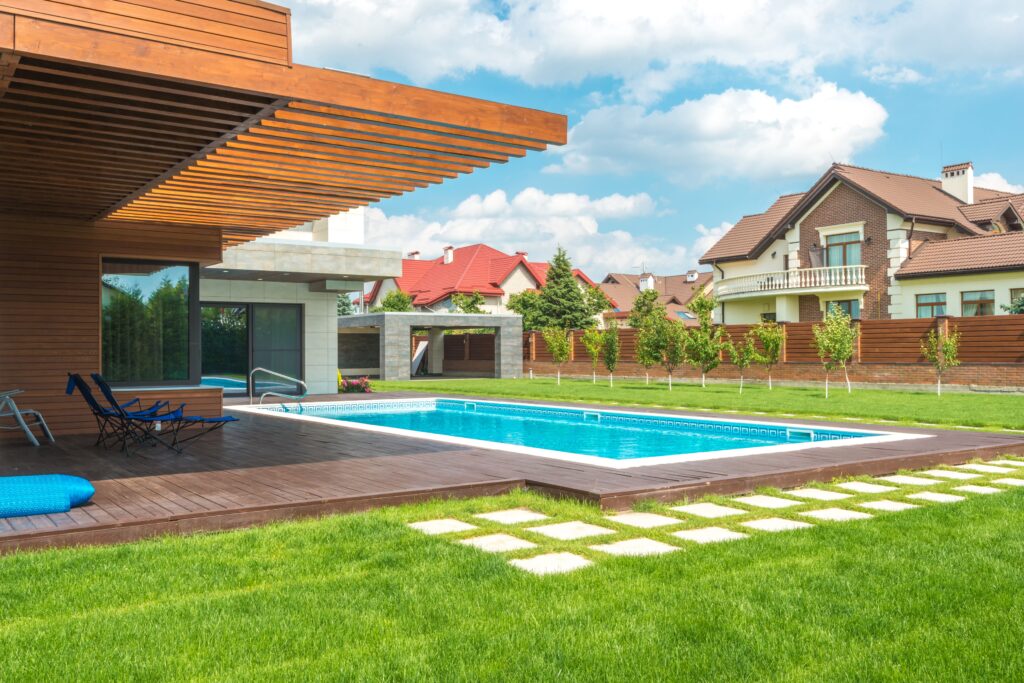 Backyard swimming pool with a paver deck (illustrative stock photo, not a Watermark job)