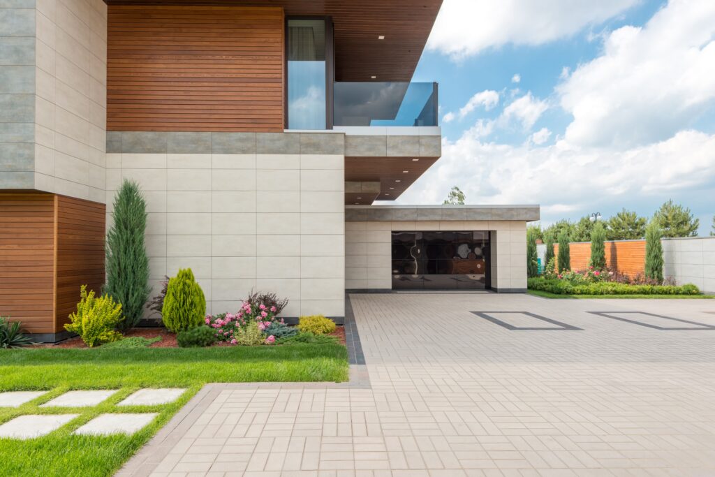 Paver driveway leading to a modern home (illustrative stock photo, not a Watermark job)