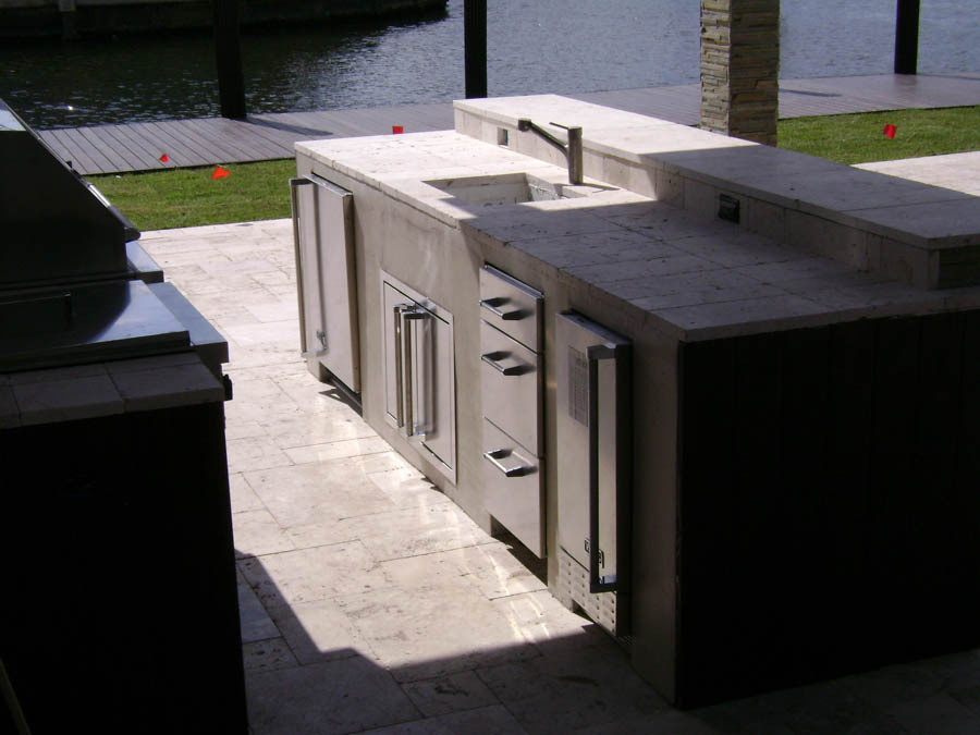 Outdoor kitchen and seating area on a waterfront deck
