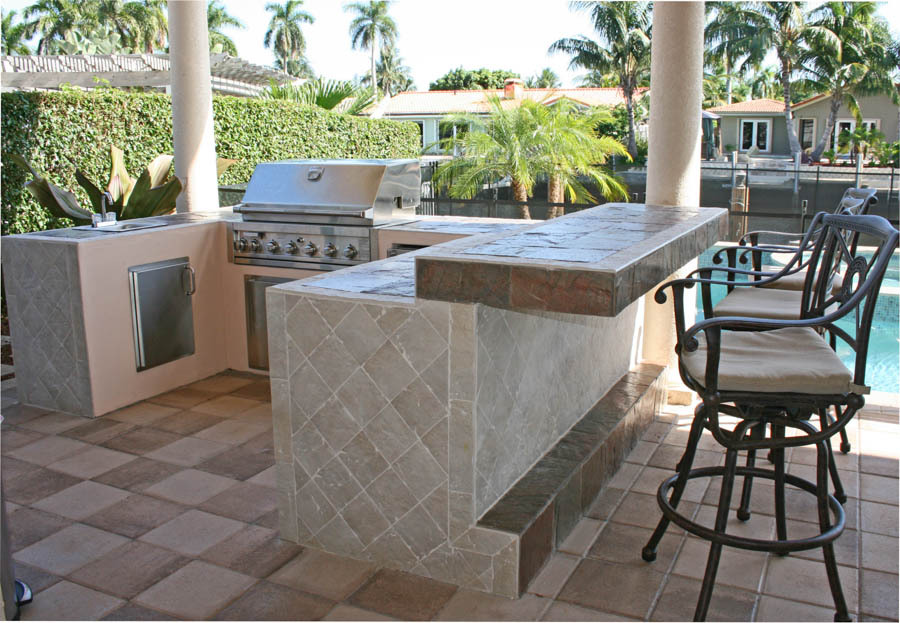 Custom outdoor kitchen beside a pool