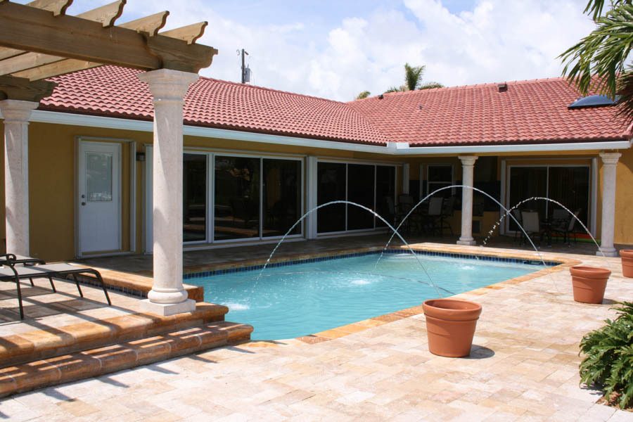 Courtyard pool with deck jets and a pergola